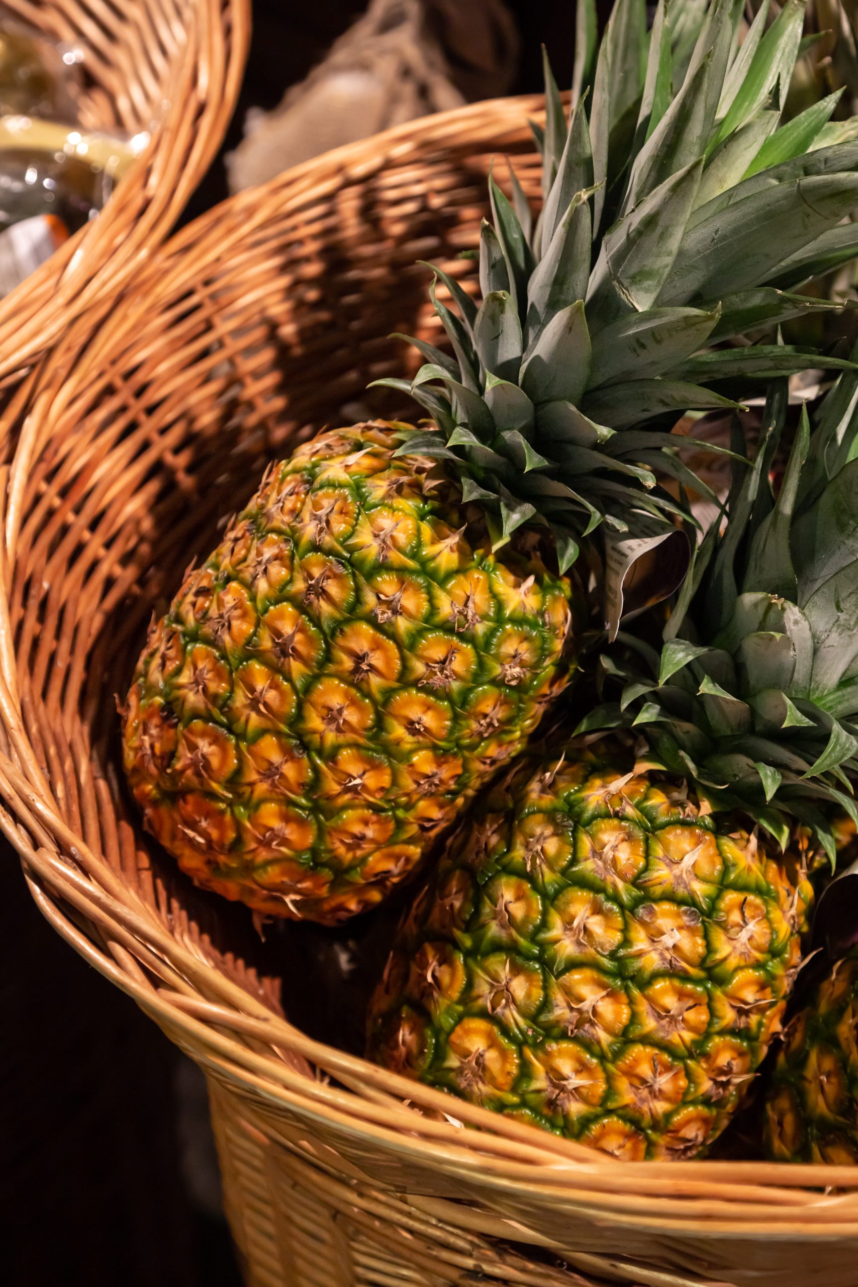 Pineapples fruit in a basket at the supermarket.
